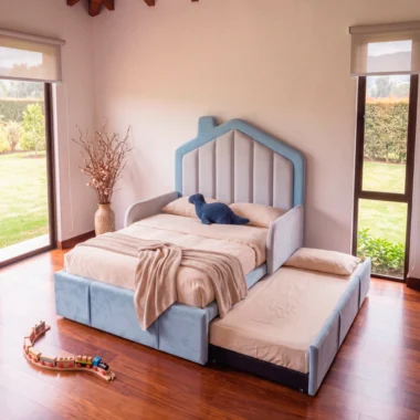 Cama infantil tapizada en azul con cama nido auxiliar desplegada